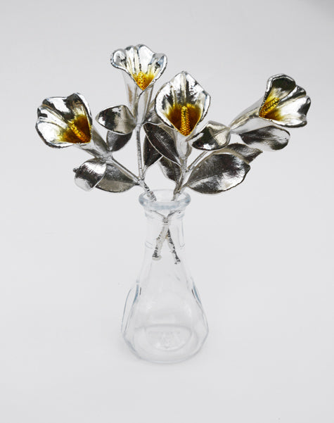 pair of silver covered real lilies in vase