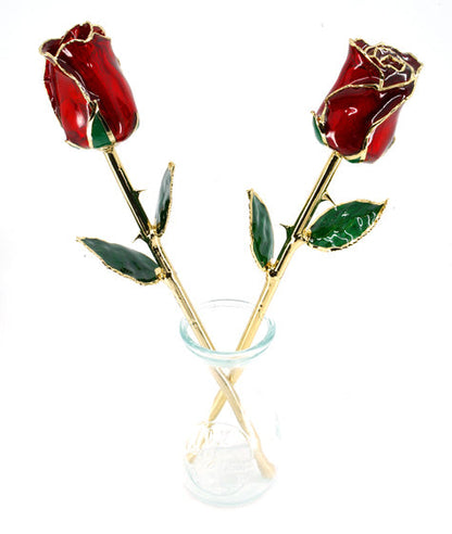 pair of glazed roses in glass vase