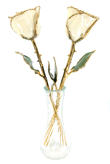 pair of ivory roses in glass vase